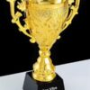 Ornate gold trophy cup with black base
