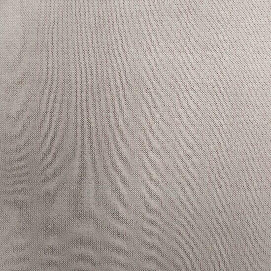 Close-up of beige textured fabric surface.